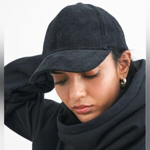 Black baseball cap with curved brim and textured fabric